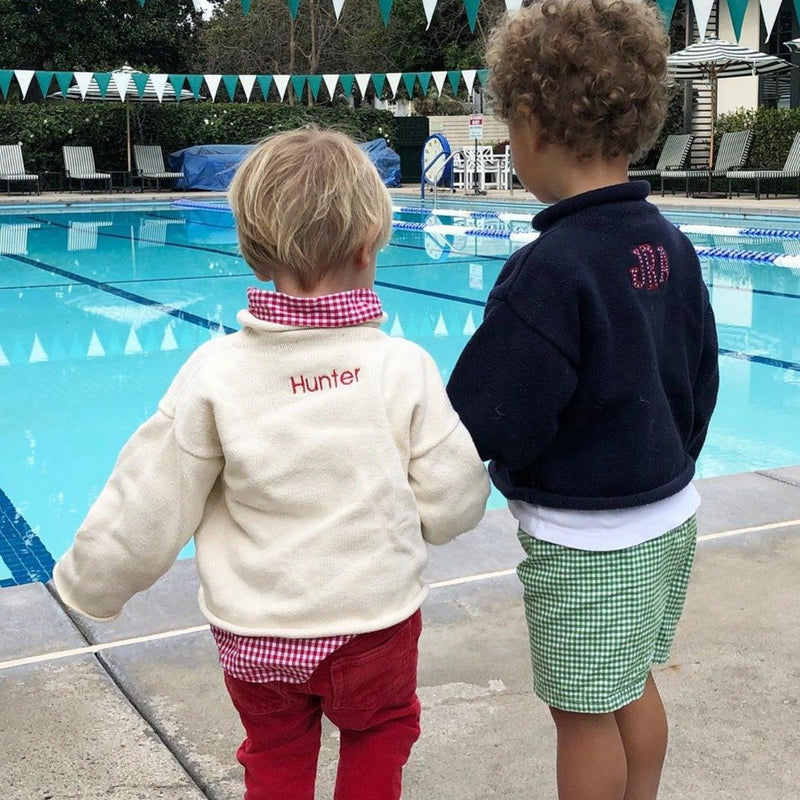 Two boys wearing rollneck sweaters with monogram and personalized with name